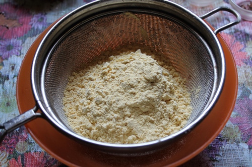 sieve gram flour in a bowl