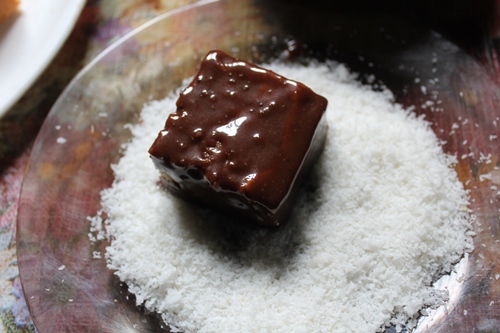 coat cake in desiccated coconut