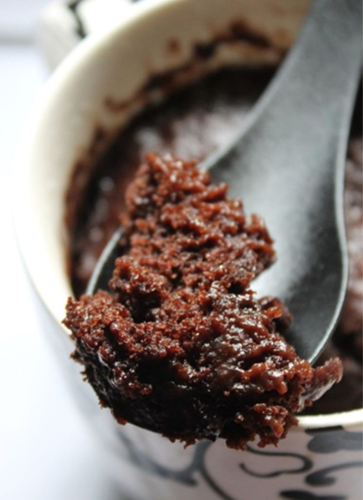 a spoon of chocolate mug cake to show the soft fluffy texture