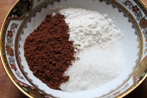 take sugar, cocoa and flour in a bowl for making mug cake
