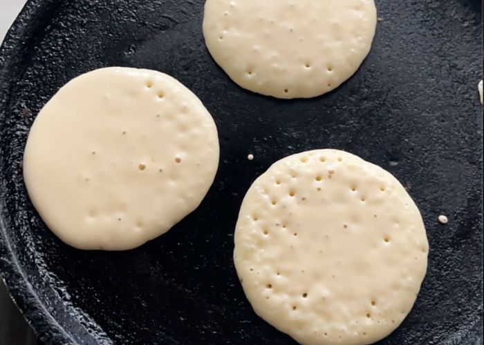 cook pancakes till bubbles form on top