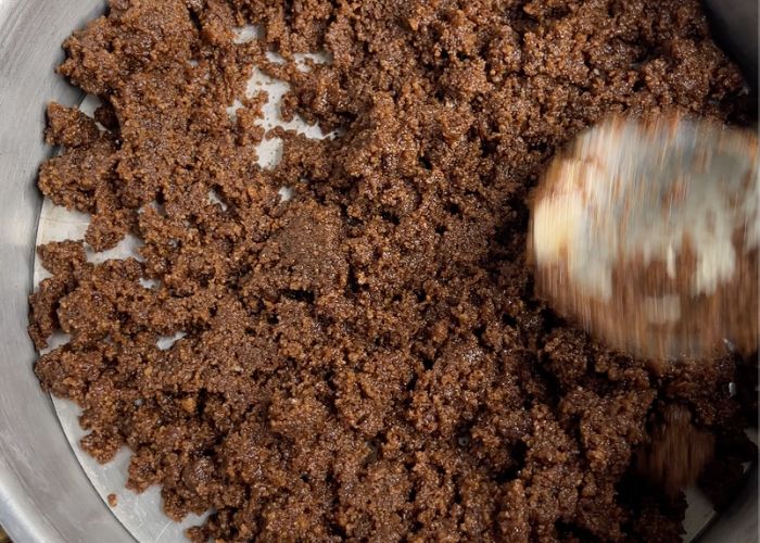 spread biscuit crumbs over the pan