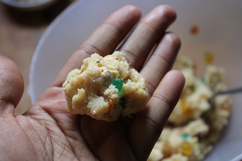 take small portion from the rava ladoo mix