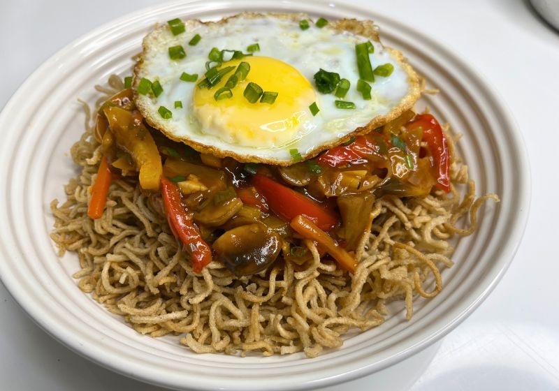 American Chop suey served with fried egg