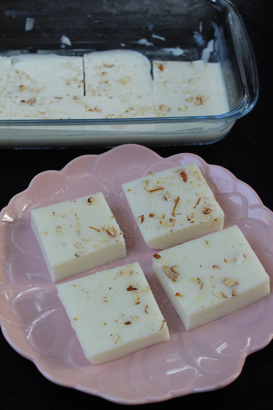 china grass pudding cut into pieces and served in glass dish