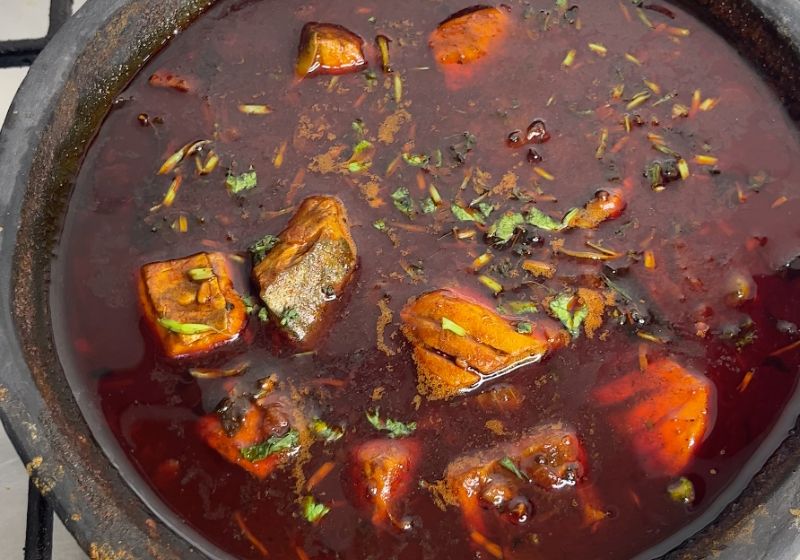 kerala meen curry cooked and garnished with coriander leaves