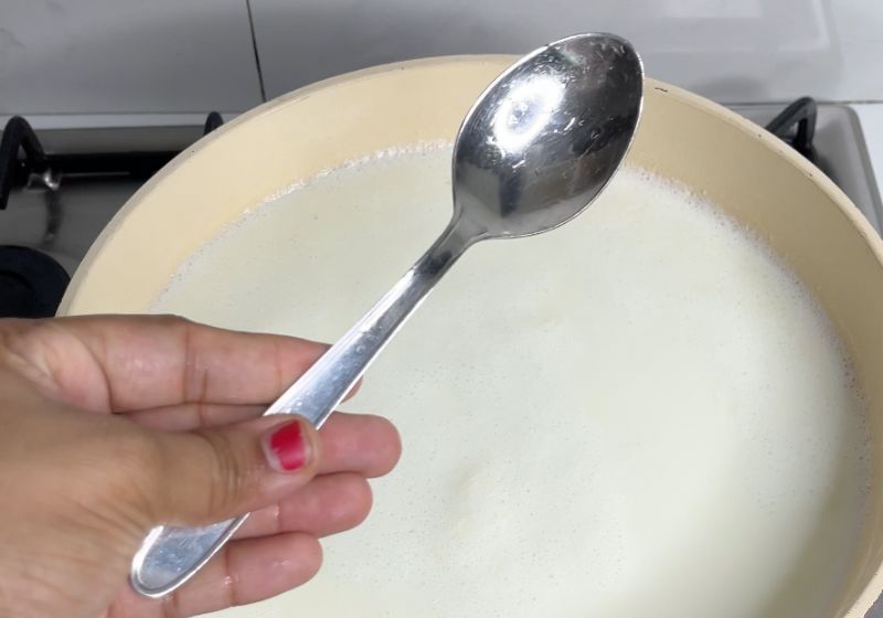 add a spoon into the milk. which prevents milk from boiling oven