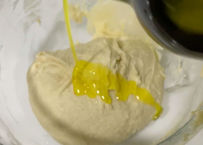 add oil and knead once