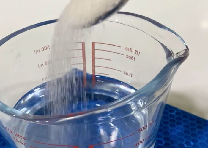 take warm water in a jug for making pullman loaf