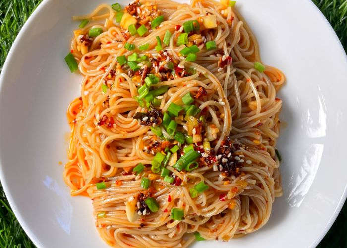 chilli oil noodles served with chilli crispy, spring onions and sesame seeds