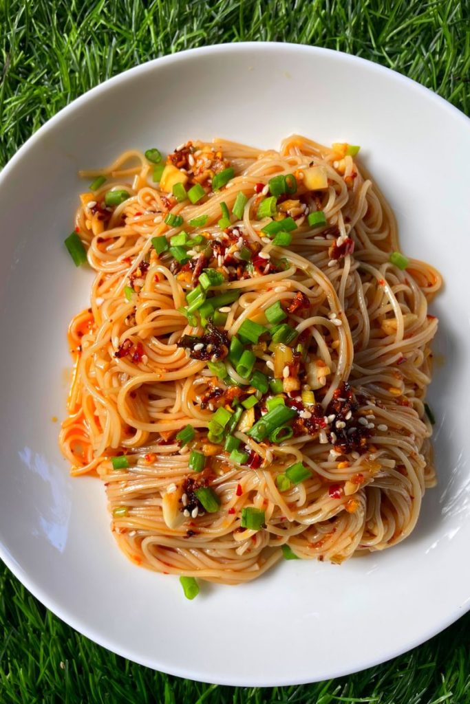 chilli oil noodles served with chilli crispy, spring onions and sesame seeds