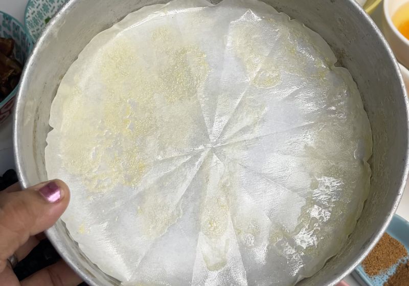 round cake pan lined with parchment paper and greased