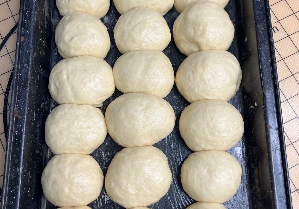 dinner rolls arranged in 9x13 baking tray