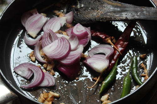 add sliced onions, dry red chillies and green chillies