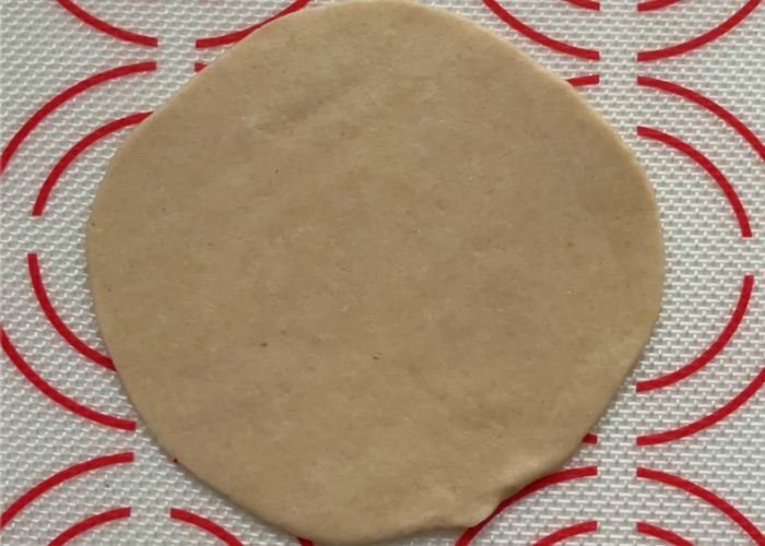 roll puri dough ball into a circle disc