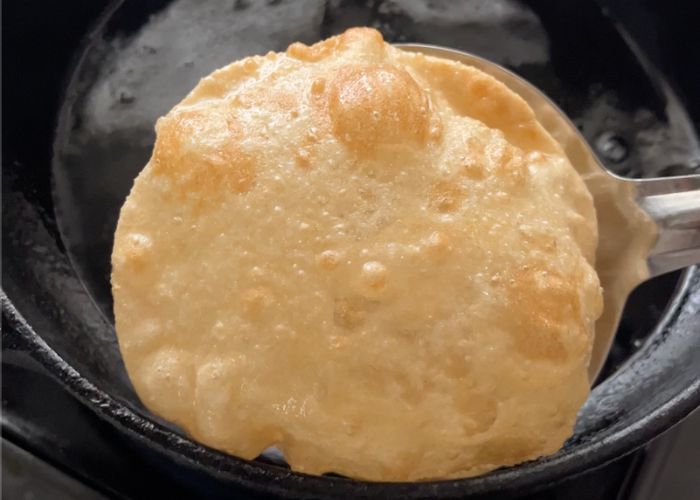 strain puffed poori using slotted spoon