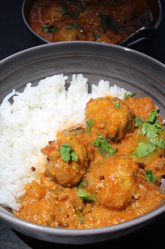 paruppu urundai kuzhambu served with steamed rice in a bowl