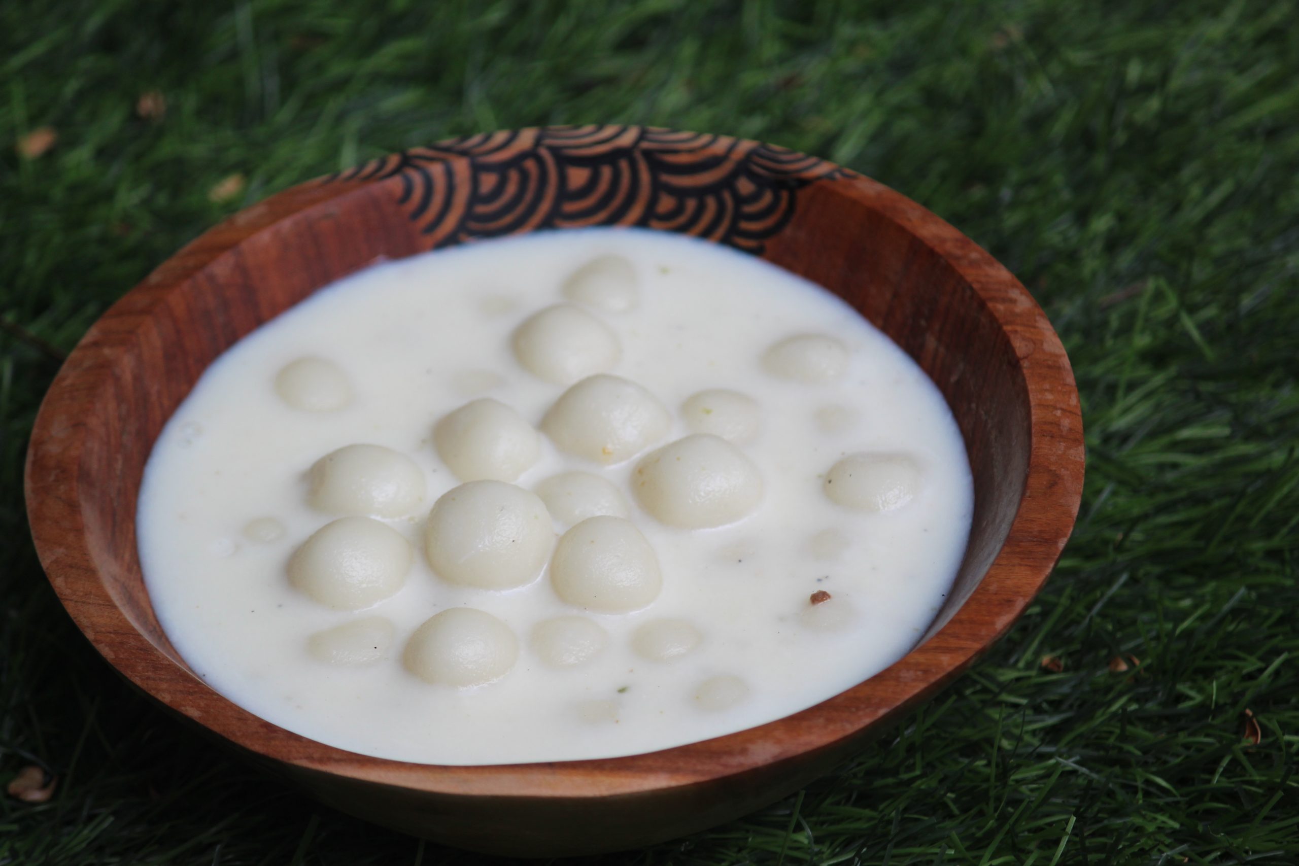 paal kozhukattai served in a wooden serving bowl