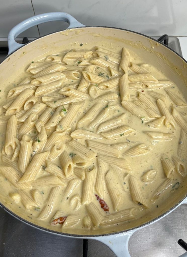 cooked pasta mixed with homemade alfredo sauce