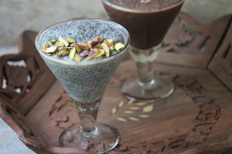 chia pudding served in glass with nuts on top