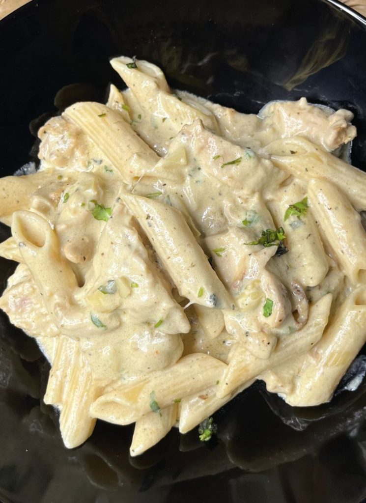 close look of chicken alfredo pasta tosed with homemade alfredo sauce