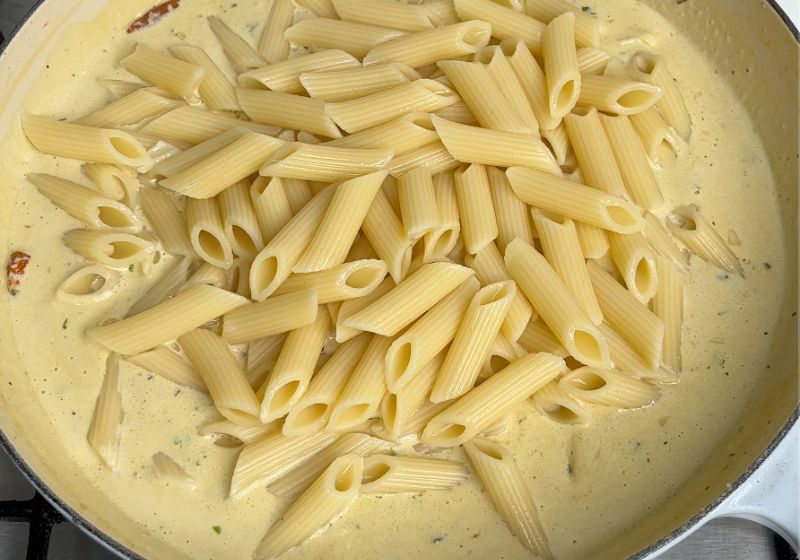 add cooked pasta in the alfredo sauce