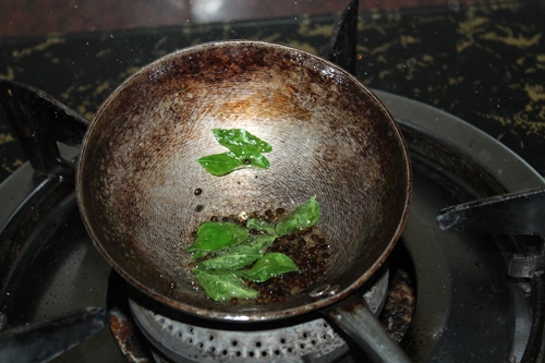 tempering mustard seeds, urad dal and curry leaves