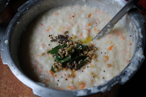 mixing yogurt rice with tempered spices