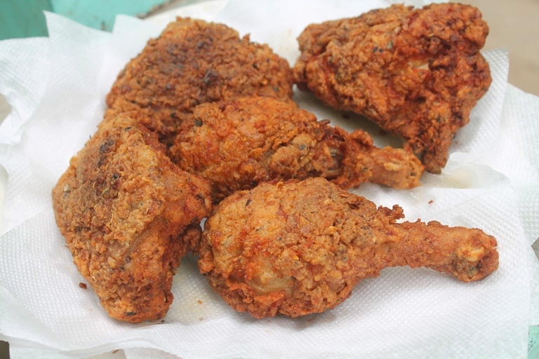 fried chicken placed on a paper towel to remove excess oil