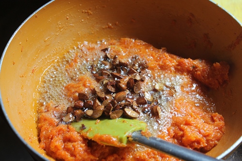 pour fried nuts over carrot halwa