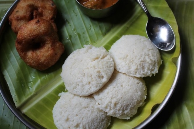 idli served on a banana leaf with medu vada, sambar and filter coffee