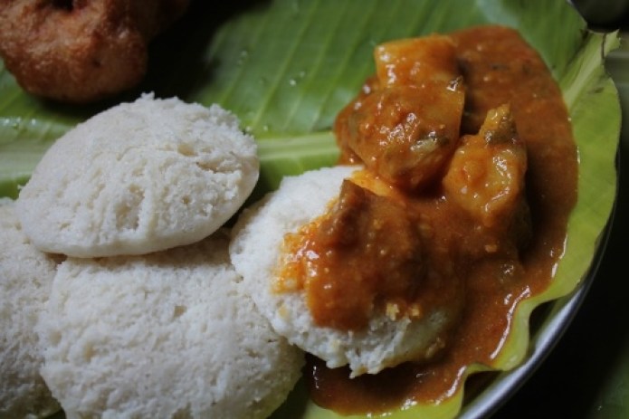 idli served on a banana leaf with medu vada, sambar and filter coffee