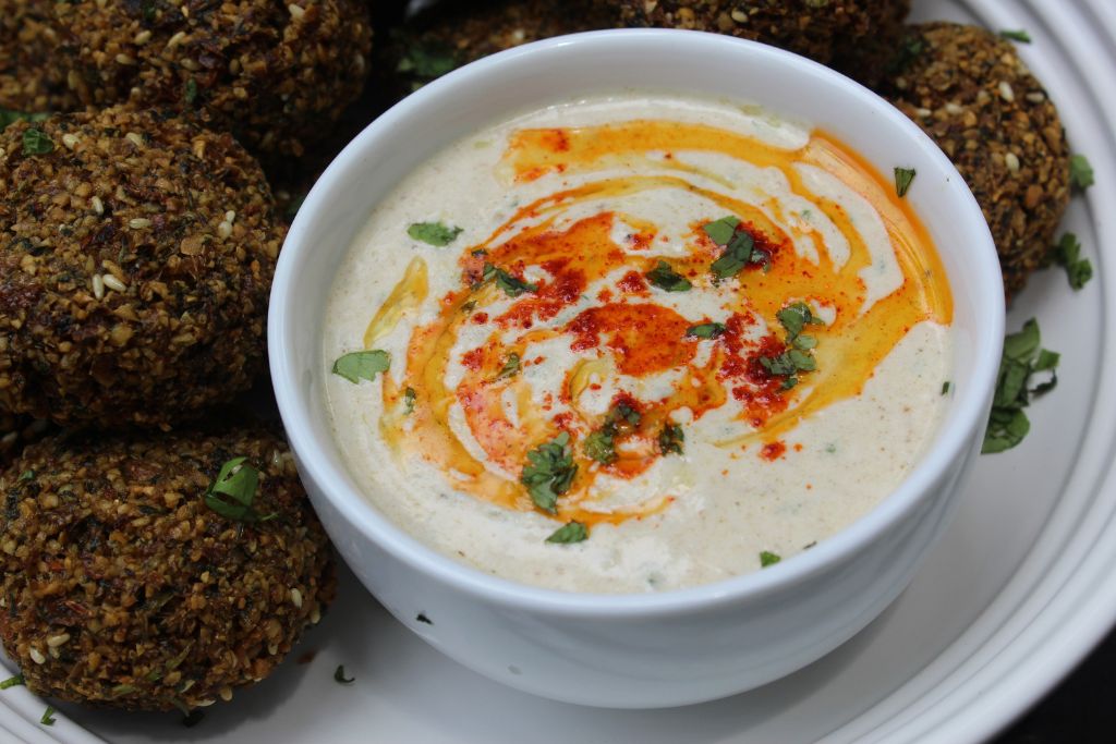 tahini sauce served with falafels with a drizzle of olive oil