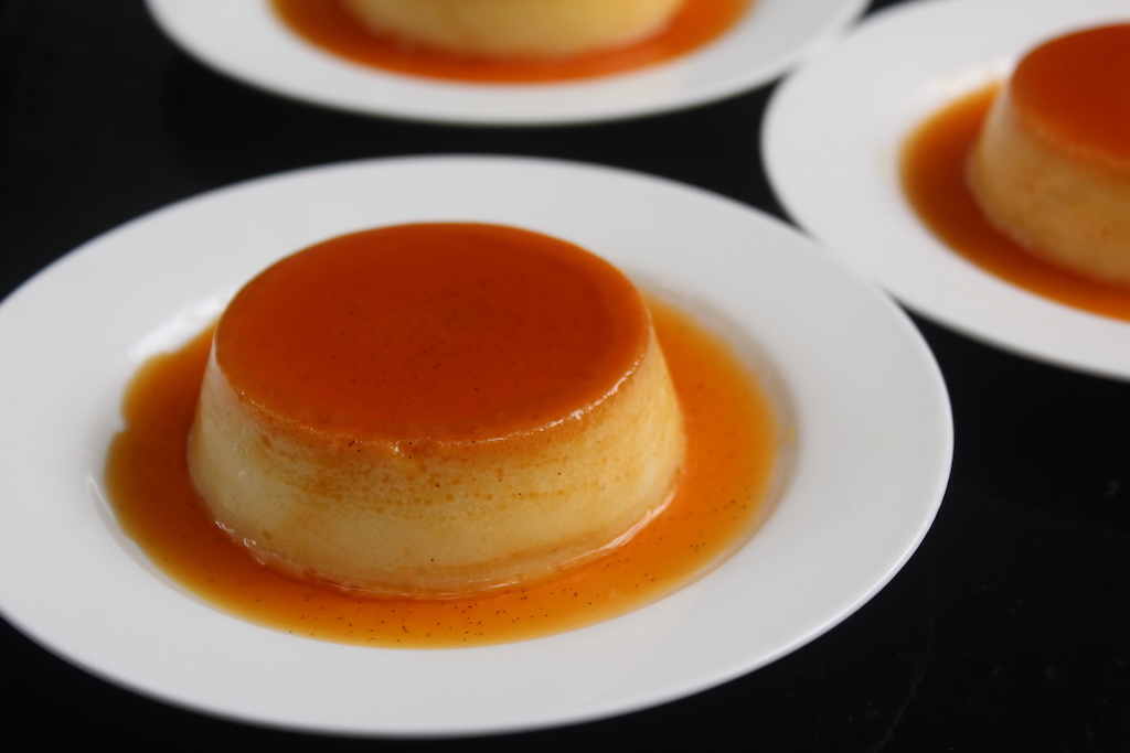 caramel custard served with caramel sauce in a white plate