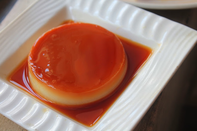 Eggless Caramel Custard in a white plate with caramel sauce