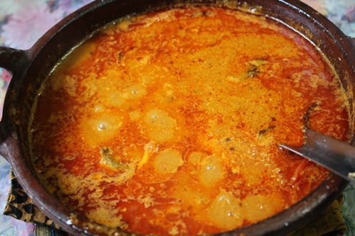 fish curry with oil floating on top