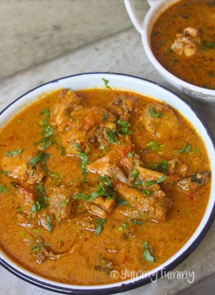 chicken kulambu garnished with coriander leaves