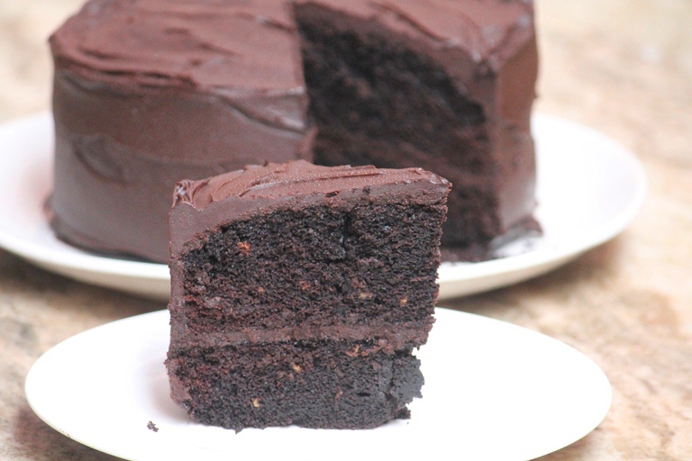 a slice of Eggless Chocolate Cake served in a white plate