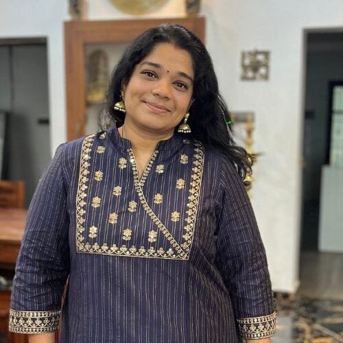 Aarthi Satheesh, founder of Yummy Tummy in a blue blouse inside her home. 